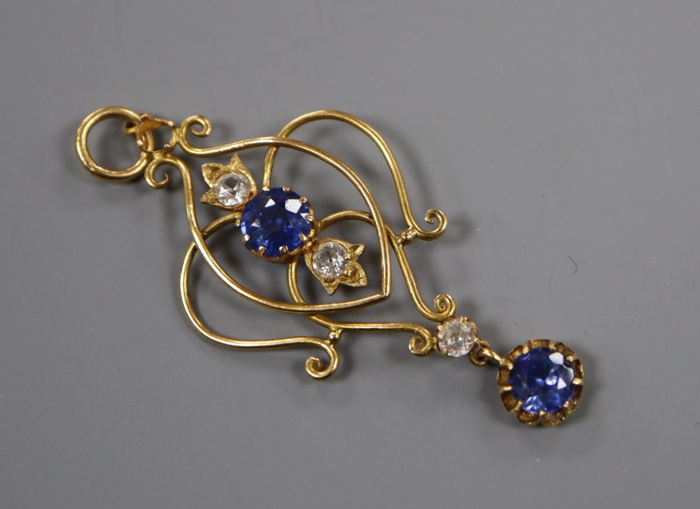 An early 20th century yellow metal, two stone sapphire and three (ex 4) white stone set drop pendant, overall 47mm gross 3 grams.